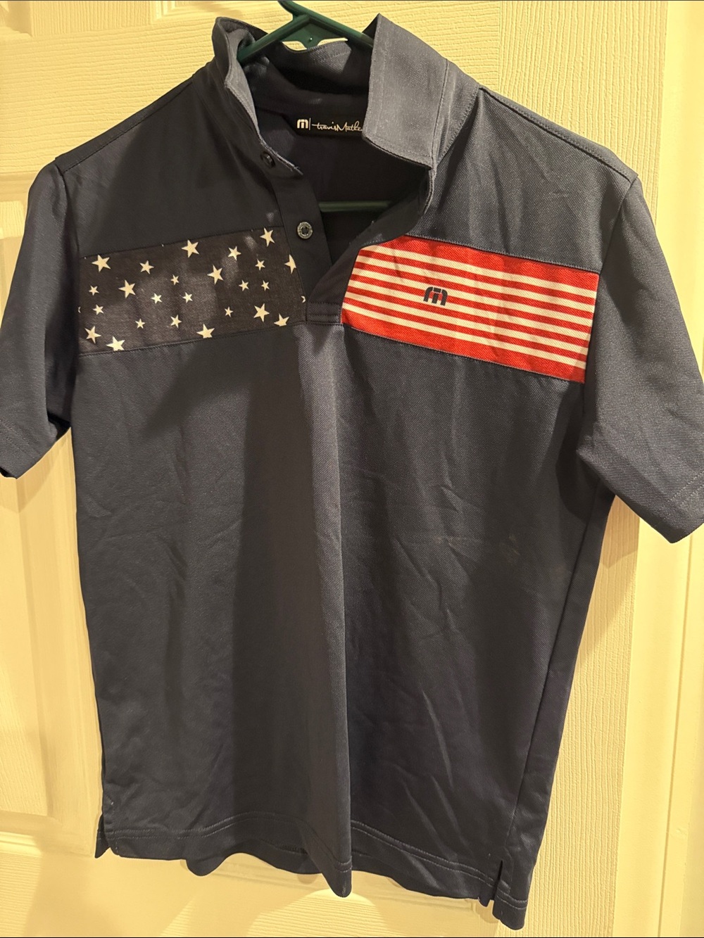 Travis Mathew Navy Polo with Red & White Flag Panels